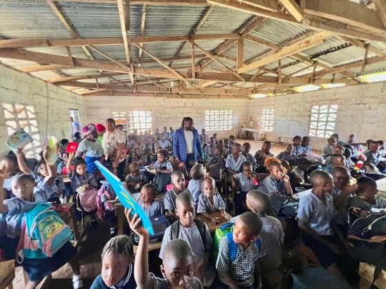 Pupils raise their new learning materials in class