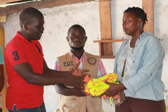 Presenting football boots to a local club