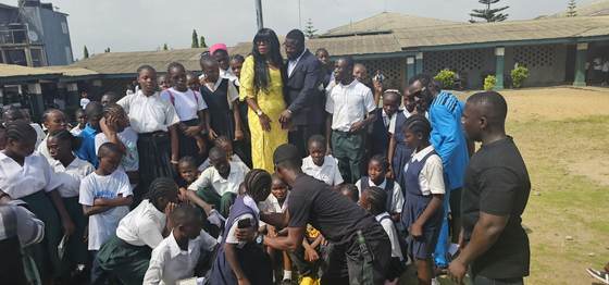 Pupils crowd around the Friends of Tapson team