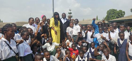 Pupils and staff gather in the schoolyard