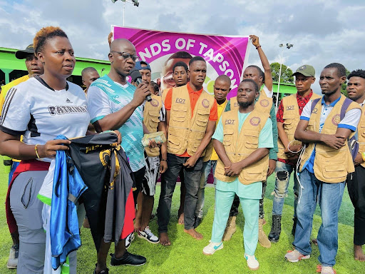 Handing over sponsorship supplies to the team